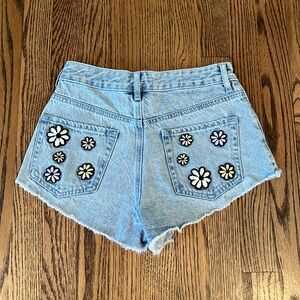 PACSUN women’s cut off Jean shorts size 24, back pocket patch flower detail